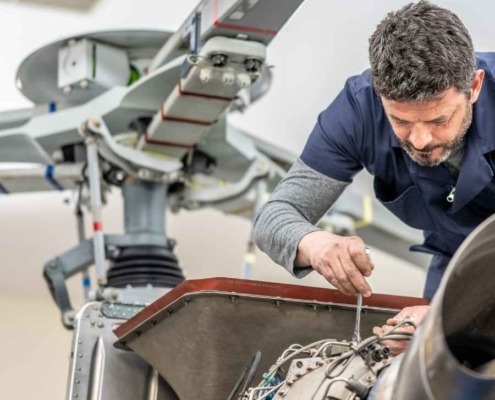 Helicopter engineer works on helicopter using MGC Aerospace components